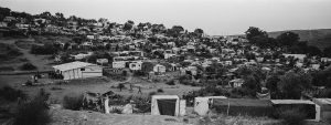 24 August 2020 – Makeshift shelters cover a hillside outside the official refugee camp at Moria, Lesbos, Greece. As a result of overcrowding, the camp expanded into a nearby olive grove, which became known as the ‘Moria jungle’. Living quarters were largely makeshift, made from pallets and tarpaulins.