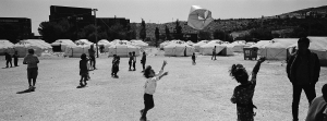 26 April 2016 – Children play with a plastic bag at a camp for refugees and migrants in Schisto, near Athens, Greece.