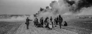 6 April 2019 – People face a cloud of smoke in clashes with police near a refugee camp in the village of Diavata near Thessaloniki, Greece.Trouble flared outside the camp on 4 April, after a social media rumour suggested onward travel restrictions had been lifted. Some 500 migrants announced their intention to march to the border with northern Macedonia, some 60 kilometers away, and on to Central Europe.