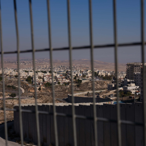 23 December 2019 – A separation barrier divides the Pisgat Zeev Israeli Settlement (left) from the Shuafat Refugee Camp, near Jerusalem. Palestinians complain of a feeling of being perpetually trapped behind the barrier, as if they lived in a large open-air prison.