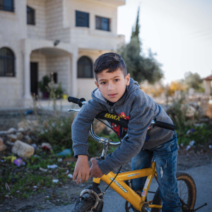20 December 2019 – Majd Rimawi rides his bicycle in front of the family home, in Beit Rima, Palestine. Majd, whose father has been in jail since 2001 serving a 25-year sentence, was conceived using IVF.