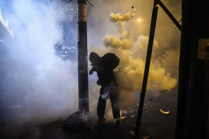 12 November 2020 – A demonstrator returns a tear gas bomb fired by the police, during a protest against the new government of interim president Manuel Merino, on Avenida Abancay, Lima, Peru.