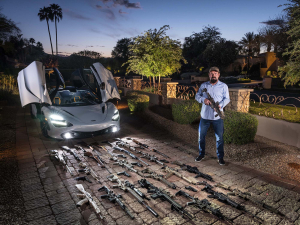 19 April 2019 – Charlie Ferer with some of his firearms outside his house in Paradise Valley, Arizona, USA. After training as an economist, he ran a business making artificial grass, then in 2012 founded a company that manufactures munitions and provides training and intelligence solutions to US and non-US government clients.