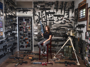20 April 2019 – Danyela D’Angelo sits with a collection of firearms in a vault in Arizona, USA. The collection comprises hundreds of firearms, historic Second World War pieces, weapons of war, and prototypes. It forms part of a trust held in her name until she comes of age. Danyela learned to shoot from her father when she was 12, and since then has competed in shooting events across the US, firing around 3,000 rounds a month.