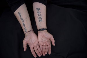29 August 2019 – Leila Shamo (34) displays tattoos she made while enslaved by Islamic State militants, at her home near Khanke Camp, near Dohuk, Iraq. She used her breast milk, charcoal ash, and a needle to write the name of her husband on the front of her hand, and her two sons and the date they were all captured on the inside of her forearms.