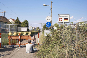 25 April 2020 – A Swiss-German couple meets at the closed border on Lettackerweg, in Riehen, Switzerland.