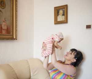 17 July 2015 – Ewa holds up her reborn doll, in Bytom, Poland. She says the doll reminds her of her niece when she was a little baby, and keeps her company.