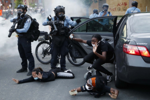 31 May 2020 – Police order motorists from their vehicle and to the ground, during a protest on South Washington Avenue, in Minneapolis, Minnesota, USA.